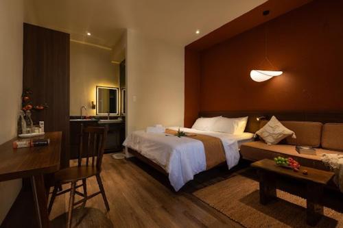 a bedroom with a large bed and a couch at PINhome in Ho Chi Minh City