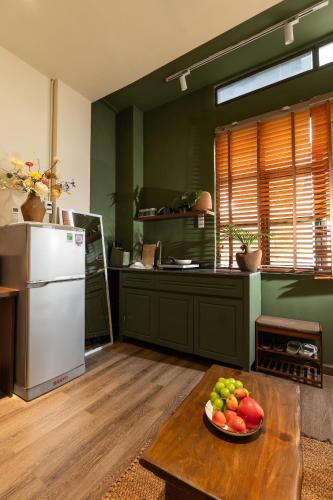 a kitchen with a plate of fruit on a table at PINhome in Ho Chi Minh City