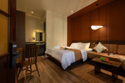 a hotel room with a bed and a couch at PINhome in Ho Chi Minh City