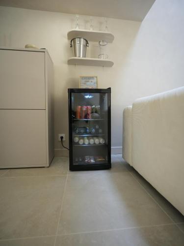 a small refrigerator in a room with a wall at crystal stay in Melun