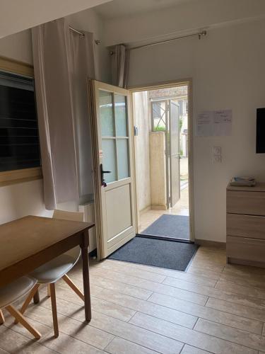 a room with a door open to aoyer with a table at Le Miribel in Miribel