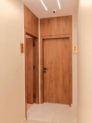 an empty room with a wooden door in a room at Pyramids INN View in Cairo