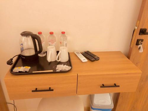 a table with a tea kettle and bottles of water on it at Pyramids INN View in Cairo