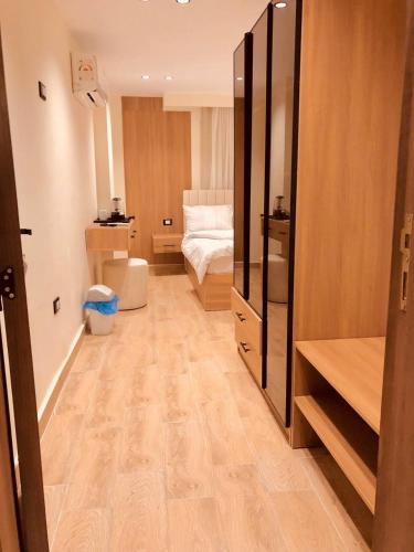 a room with a bedroom with a bed and a mirror at Pyramids INN View in Cairo