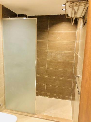 a shower with a glass door in a bathroom at Pyramids INN View in Cairo