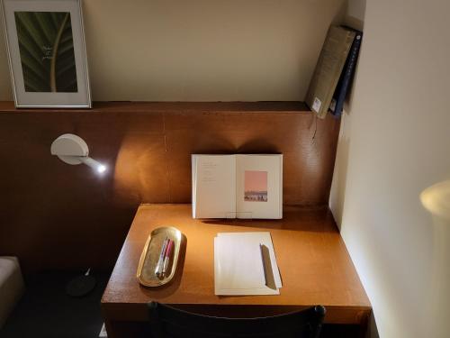 a desk with a phone and a book on it at jeonju hotel book and type in Jeonju