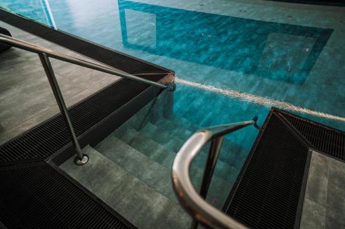 an escalator leading into a swimming pool at Allgäuer Bergwald Chalets in Oberstaufen