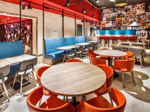 a restaurant with tables and chairs in a room at ibis Styles London Ealing in London