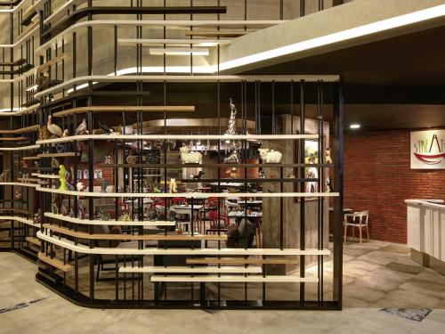 a room with a shelf with a lot of products at Ibis Styles Makassar Sam Ratulangi in Makassar