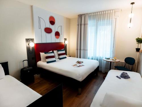 Ένα ή περισσότερα κρεβάτια σε δωμάτιο στο Ibis Styles Rouen Centre Cathédrale