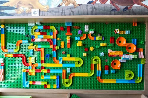 a toy maze with different toys on a shelf at Hakuna Stays in Makassar
