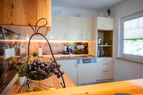 a kitchen with a basket of grapes on a counter at EHM Elegantes Design Apartment zwischen Linz&Wels in Pucking
