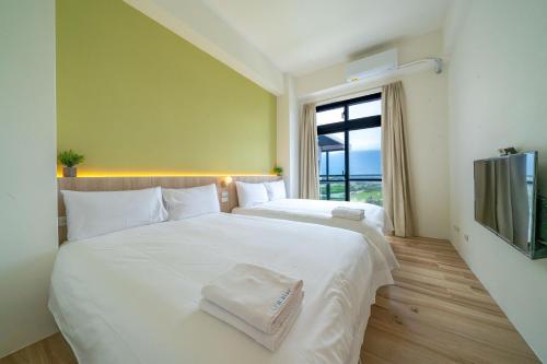 Cama o camas de una habitación en 冉冉七星潭海景民宿