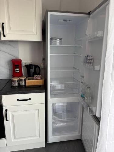 a white refrigerator with its door open in a kitchen at Auszeit in Volkertshausen