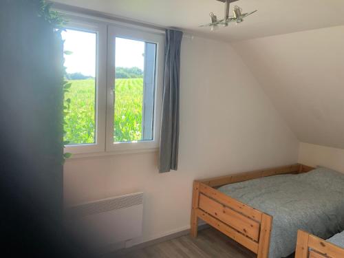 a bedroom with a bed and a window at Cozy family home in Champagne-en-Ardenne 8p in Rubigny