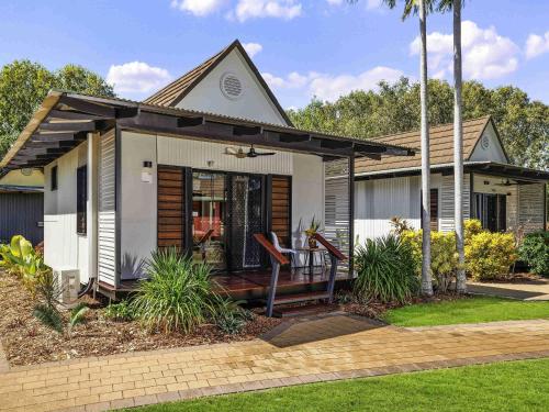 a small house with a porch and a patio at Mercure Darwin Airport Resort in Darwin