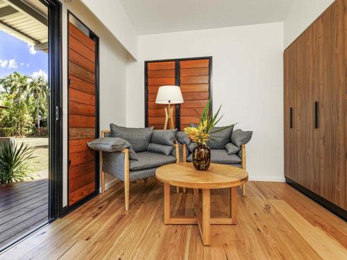 a living room with a couch and a table at Mercure Darwin Airport Resort in Darwin