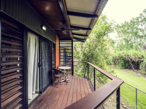 a balcony of a house with a table and a chair at Mercure Darwin Airport Resort in Darwin