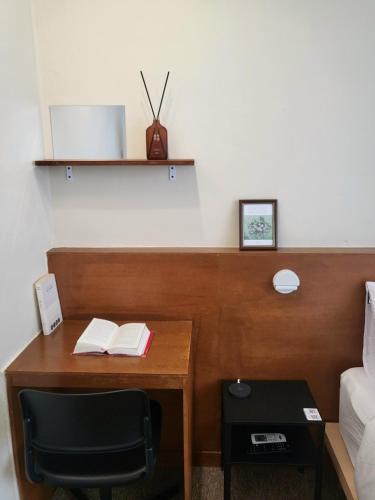 a bedroom with a desk with a bed and a bed at jeonju hotel book and type in Jeonju
