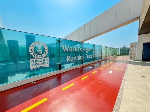 a building with a walkway with a red floor at Stylish 1BR in Wasl 1 with Balcony & Pool in Dubai