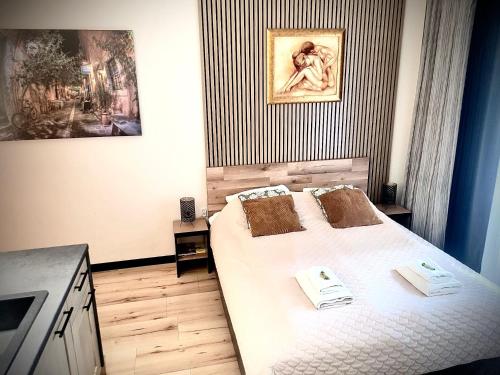 a bedroom with a bed with two towels on it at Apartament przy Starówce z tarasem in Elblag