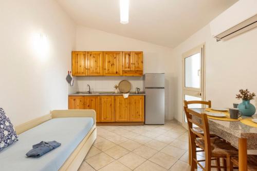 a kitchen with a couch and a table in a room at Argentario Garden House in Albinia