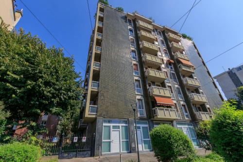 an apartment building on the corner of a street at I-Host Apartment - Ripamonti 205 in Milan