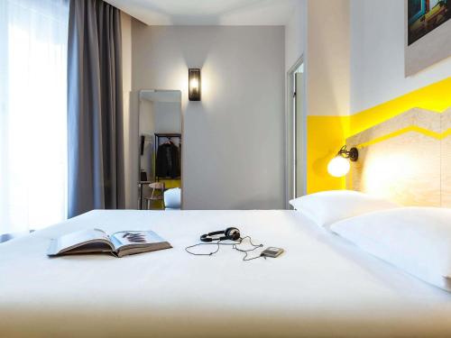 Ένα ή περισσότερα κρεβάτια σε δωμάτιο στο ibis Styles Paris Nation Porte De Montreuil