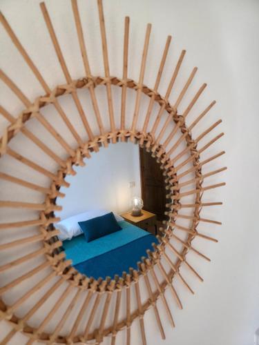 a bedroom with a bed and a mirror at Domu Malaspina in Bosa