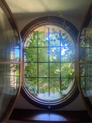 a round window with a view of a garden at Gästehaus Benediktinerstift Göttweig - Bed & Breakfast Monastery in Furth