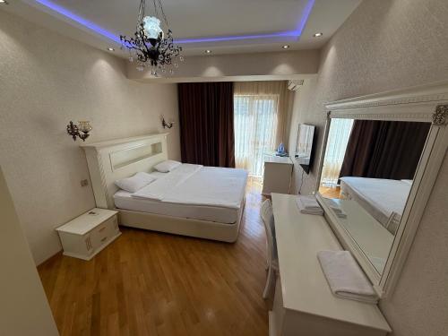 a bedroom with two beds and a mirror in it at Park Azure 0313 in Baku