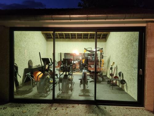 a view of a gym through a glass window at Château de la Rochetière in Marcilloles