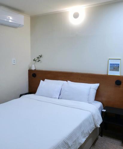 a bedroom with two beds with white pillows at jeonju hotel book and type in Jeonju
