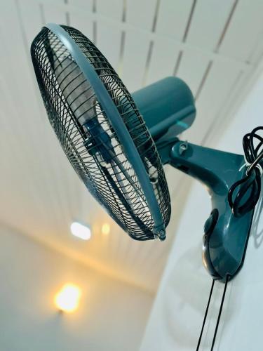 a blue fan is hanging from a ceiling at Rathnayaka Family & Holiday Home in Anuradhapura