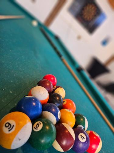 a pile of billiard balls on top of a pool table at casa de vicky in El Puerto de Santa María