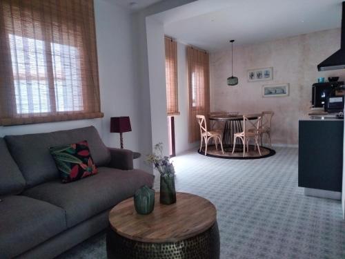 a living room with a couch and a table at Verde Oliva apartamento in Vejer de la Frontera