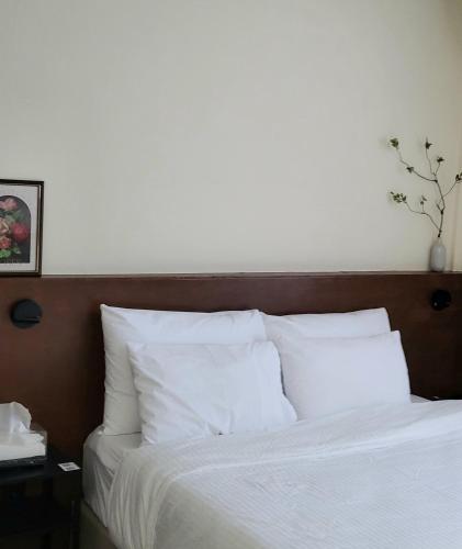 a bed with white sheets and pillows in a bedroom at jeonju hotel book and type in Jeonju