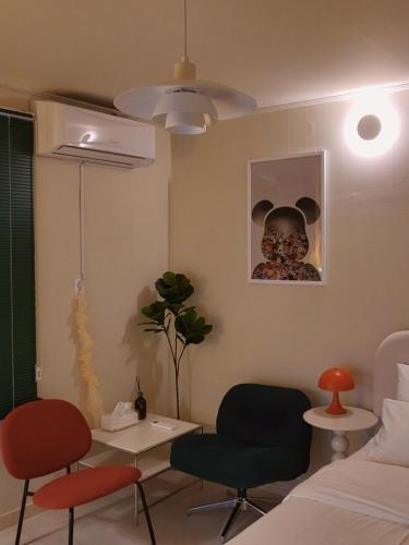 a room with a bed and two chairs and a table at jeonju hotel book and type in Jeonju