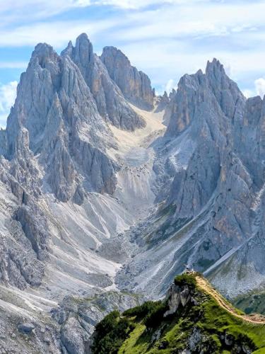 a mountain range with a road in front of it at Appartamento Comelico Dolomiti in Candide