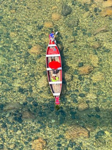a boat in the water with a person in it at Shawn camps shnongpdeng in Shillong