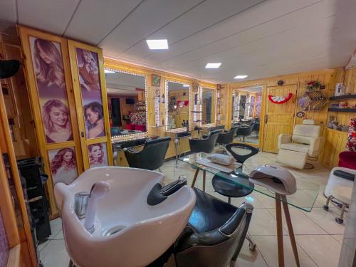 a hair salon with a bunch of chairs and a sink at Senhaja Hôtel et Spa in Jenane Sidi Amer