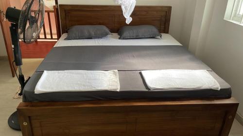 a bed with two pillows on it in a room at BAWANS VILLA Holiday Home for Family or Group in Hikkaduwa