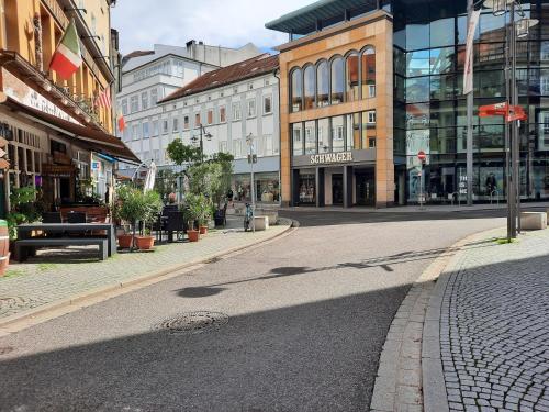 an empty street in a city with buildings at A7 J22 FeWo Michelangelo NETFLIX Fußgängerzone in Eisenach