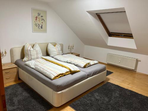 a couch with pillows on it in a living room at Dachgeschoss Wohnung in Langerringen