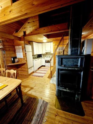 a kitchen with a stove in the middle of a room at Yllästölli 2B in Äkäslompolo