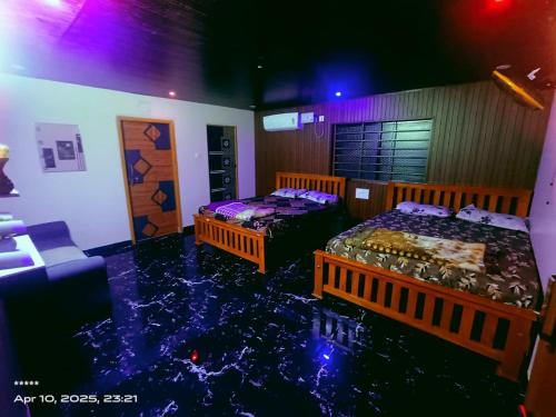 two beds in a room with water in the floor at Ocean pearl homestay2 in Kāsarkod
