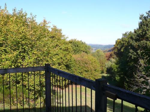 a wooden fence with trees in the background at Gîte de la Colombière in La Grande-Verrière
