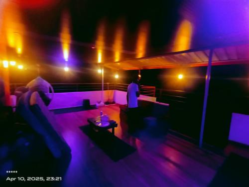 a living room with purple lights and a couch at Ocean pearl homestay2 in Kāsarkod