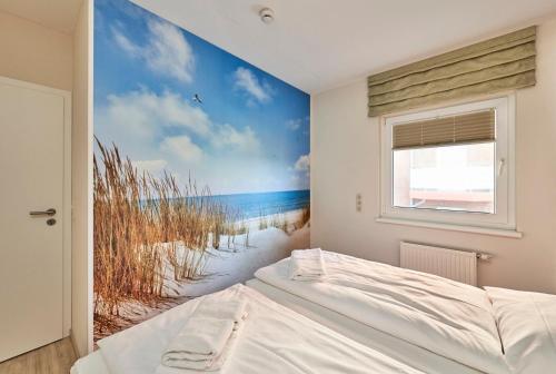 a bedroom with a beach mural on the wall at Pamir - 25 in Cuxhaven