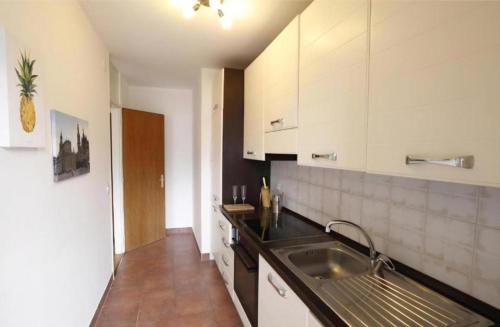 a kitchen with a sink and a counter top at Melide Apartments Lake Lugano close to Swissminiatur & Private Parking on Request with Limited Availability in Melide